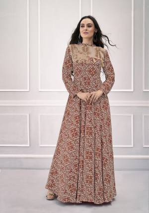 Rich And Elegant Looking Designer Readymade Gown Is Here In Brown Color Fabricated On Rayon. It Is All Beautified With Intricate Prints, And Hand work Over The Yoke. 