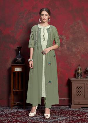 Here Is A Beautiful Jacket Patterned Designer Readymade Kurti In Off-White Colored Inner With Olive Green Colored Jacket. Printed Inner Is Fabricated On Rayon Cotton Paired With Muslin Fabricated Embroidered Jacket. It Is Light In Weight And Easy To Carry All Day Long. 