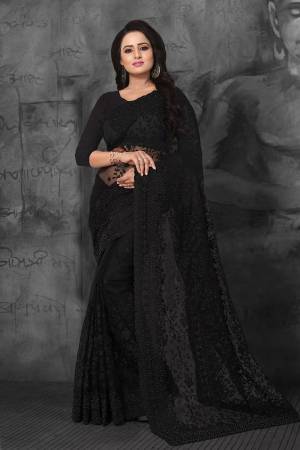 Here Is A Very Beautiful Heavy Embroidered Designer Saree In Black Color. This Saree And Blouse are Fabricated On Net Beautified With Tone To Tone Heavy Resham Embroidery With Ceramic Stone Work. Its  Embroidery Gives Heavy And Subtle Look To Your Personality Both At The Same Time. 