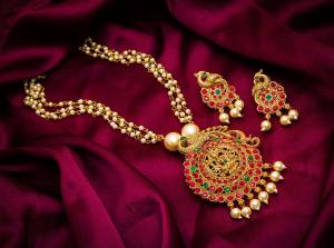 Give An Enhanced Look To Your Personality By Pairing Up This Beautiful Necklace Set With Your Ethnic Attire. This Pretty Set Is In Golden Color Beautified With Stone And Pearl Work. Buy Now.