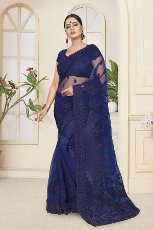 Enhance Your Personality In This Heavy And Attractive Looking Designer Saree In Royal Blue Color. This Saree And Blouse are Net Based Beautified With Tone To Tone Resham Embroidery And Ceramic Stone Work