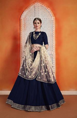 For A Royal Queen Look, Grab This Designer Lehenga Choli Navy Blue Color Paired With Contrasting Cream Colored Dupatta. This Beautiful Lehenga Choli Is Fabricated On Art Silk Paired With Net Fabricated Dupatta. Buy This Now.