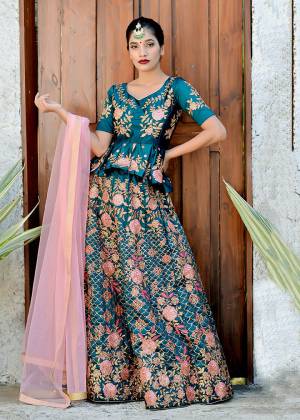 Here Is A Very Pretty Peplum Patterned Heavy Designer Lehenga Choli Is Here In Teal Blue Color Paired With Contrasting Baby Pink Colored Blouse. This Lehenga Choli Is Satin Silk Based Paired With Net Fabricated Dupatta. It Is Beautified With Heavy Contrasting Embroidery Giving It An Attractive Look. 