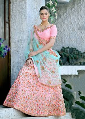 Look Pretty In This Very Beautiful Heavy Designer Lehenga Choli In Pink Color Paired With Contrasting Aqua Blue Colored Dupatta. Its Heavy Embroidered blouse And lehenga Are Fabricated On Art Silk Paired With Net Fabricated Dupatta. It Has Contrasting Embroidery Which Gives An Attractive Look All Over. 