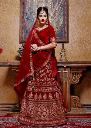 Here Is The Trending Designer Lehenga Choli With Two Dupatta Concept In All Over Maroon Color. Its Blouse And Lehenga Are Fabricated On Velvet Paired With Georgette Fabricated Dupatta And A Velvet Shawl. This Shawl Look Gives A Royal Look To Your Personality. 