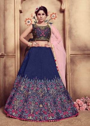 Enhance Your Personality Wearing This Heavy Designer Lehenga Choli In Navy Blue Color Paired With Contrasting Pink Colored Dupatta. Its Blouse And Lehenga Are Fabricated On Art Silk Paired With Net Fabricated Dupatta. It Is Beautified With Embroidery and Rubber Foil Prints. 