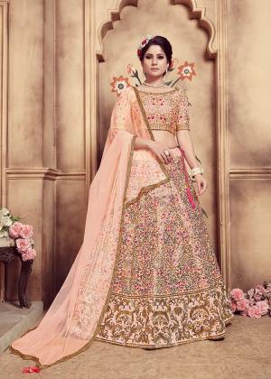 You Will Definitely Earn Lots Of Compliments Wearing This Very Pretty And Heavy Designer Lehenga Choli In Peach Color. Its Blouse And Lehenga Are Art Silk Based Paired With Net Fabricated Dupatta. It Is Beautified With Contrasting Thread And Jari Work Which Gives An Attractive Look To It. 