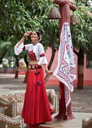 This Navratri, Adorn The Proper Traditional Look Wearing This Designer Lehenga Choli In White And Red Color. This Pretty Lehenga Choli Is Cotton Based Beautified With Multi Colored Thread Embroidery And Mirror Work. 