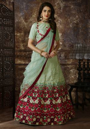 This Season Is About Subtle Shades And Pastel Play, So Grab This Very Pretty Designer Lehenga Choli In Pastel Green Color Which Is Beautified With Contrasting Colored Embroidery. Its Blouse And Lehenga Are Fabricated On Art Silk Paired With Net Fabricated Dupatta. Buy Now.