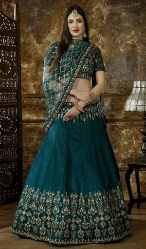 New Shade Is Here Add Into Your Wardrobe With This Heavy Designer Lehenga Choli In Teal Green Color. This Pretty Heavy Embroidered Lehenga Choli Is Fabricated On Satin Silk Paired With Net Fabricated Dupatta. Buy Now.