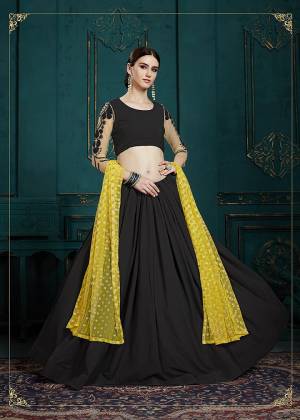 For A Bold And Beautiful Look, Grab This Designer Lehenga Choli In Black Color Paired With Yellow Colored Dupatta. Its Blouse And Lehenga Are Georgette Based Paired With Net Fabricated Dupatta. Buy This Now.