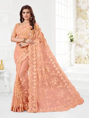 Here Is A Very Beautiful And Heavy Designer Saree In Peach Color. This Beautiful Heavy Embroidered Saree And Blouse Are Fabricated On Net Beautified With Pretty Tone To Tone Resham Embroidery And Ceramic Stone Work. Buy This Heavy Yet Subtle Looking Saree Now.