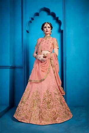 You Will Definitely Earn Lots Of Compliments Wearing This Heavy Designer Lehenga Choli In Dusty Peach Color. This Pretty Detailed Embroidered Lehenga Choli Is Silk Based Paired With Georgette Fabricated Dupatta. Buy Now.