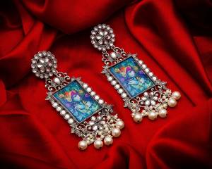 Grab This Beautiful And Attractive Pair Of Elegant Earrings Set In Silver Color. This Pretty Pair Is Beautified With Stone Work And Can Be Paired With Any Colored Traditional Attire. Buy Now.