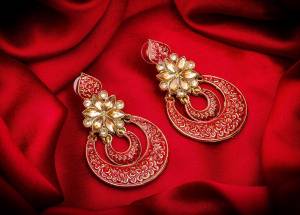 Here Is A Lovely Pair Of Earrings In Golden Color With Dark Pink Colored Highlight And Stone Work. This Can Be Paired With Any Heavy Attire Or A Simple Kurti .