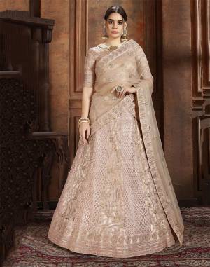 Here Is Very Elegant Looking Heavy Designer Lehenga Choli For The Upcoming Wedding Season In Pretty Rose Gold Color. This Lehenga , Choli And Dupatta Are Fabricated On Net Beautified With Heavy Detailed Embroidery. Buy Now.