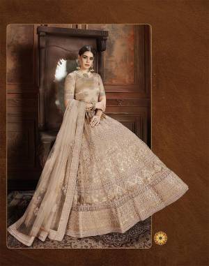 Get Ready For The Upcoming Wedding Season With This Very Beautiful Heavy Designer Lehenga Choli In Beige Color. Its Heavy Embroidered Blouse, Lehenga And Choli Are Fabricated On Net Which Is Light In Weight And Easy To Carry Throughout The Gala. 