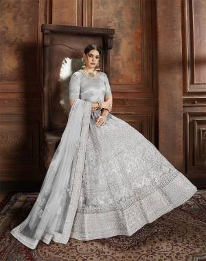 Flaunt Your Rich And Elegant Taste Wearing This Heavy Designer Lehenga Choli In Light Grey Color. This Beautifully Embroidered Heavy Lehenga Choli And Its Dupatta Are Fabricated On Net. Its Elegant Color And Detailed Embroidery Will Earn You Lots Of Compliments From Onlookers. 