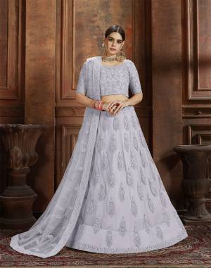 Beautiful And Elegant Looking Shade Is Here To Add Into Your Wardrobe With This Heavy Designer Lehenga Choli In Grey Color. This Lehenga Choli And Dupatta Are Fabricated On Net Beautified With Heavy Detailed Embroidery. Buy Now.