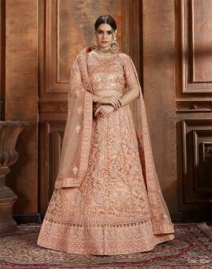 Get Ready For The Upcoming Wedding Season With This Very Beautiful Heavy Designer Lehenga Choli In Dark Peach Color. Its Heavy Embroidered Blouse, Lehenga And Choli Are Fabricated On Net Which Is Light In Weight And Easy To Carry Throughout The Gala. 