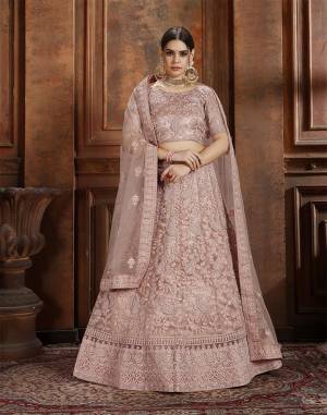 Get Ready For The Upcoming Wedding Season With This Very Beautiful Heavy Designer Lehenga Choli In Dusty Pink Color. Its Heavy Embroidered Blouse, Lehenga And Choli Are Fabricated On Net Which Is Light In Weight And Easy To Carry Throughout The Gala. 