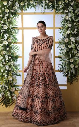 Look Pretty In This Designer Floor Length Gown In Peach Color Paired With Peach Colored Dupatta. Its Heavy Embroidered Top Is Fabricated On Net Paired With Net fabricated Dupatta. Buy This Semi-Stitched Designer Gown Now.