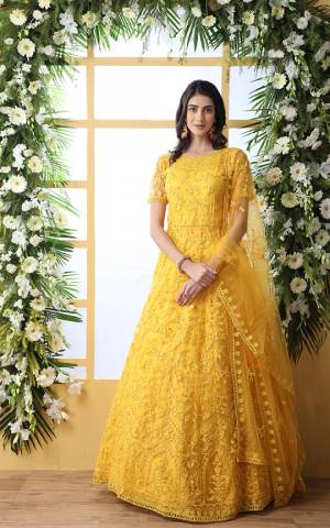 Look Pretty In This Designer Floor Length Gown In Yellow Color Paired With Peach Colored Dupatta. Its Heavy Embroidered Top Is Fabricated On Net Paired With Net fabricated Dupatta. Buy This Semi-Stitched Designer Gown Now.