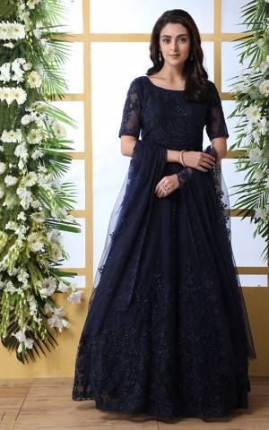 Look Pretty In This Designer Floor Length Gown In Navy Blue Color Paired With Peach Colored Dupatta. Its Heavy Embroidered Top Is Fabricated On Net Paired With Net fabricated Dupatta. Buy This Semi-Stitched Designer Gown Now.