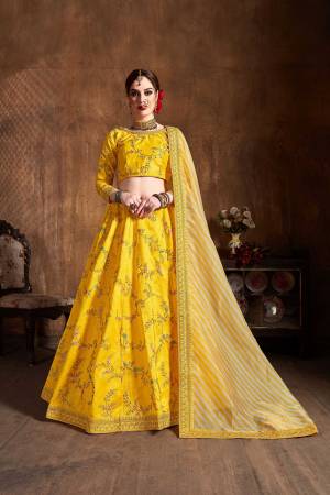 Go With The Lovely Shades Wearing This Heavy Designer Lehenga Choli In Yellow Color Paired With Yellow And White Colored Dupatta. This Heavy Embroidered Lehenga Choli Is Fabricated On Art Silk Paired With Orgenza Fabricated Dupatta. Buy This Lovely Piece Now. 