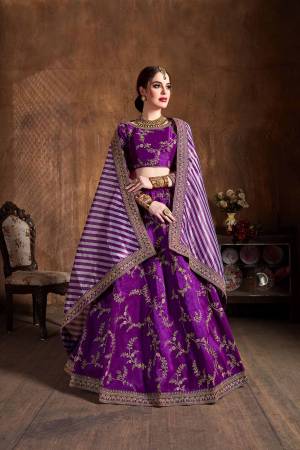 Go With The Lovely Shades Wearing This Heavy Designer Lehenga Choli In Purple Color Paired With Purple And White Colored Dupatta. This Heavy Embroidered Lehenga Choli Is Fabricated On Art Silk Paired With Orgenza Fabricated Dupatta. Buy This Lovely Piece Now. 