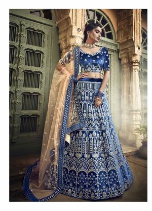 Here Is A Lovely Heavy Designer Lehenga Choli In Blue Color Paired With Contrasting Light Orange Colored Dupatta. This Heavy Embroidered Lehenga Choli Is Fabricated On Velvet Paired With Net Fabricated Dupatta. Buy This Lehenga Choli Now.