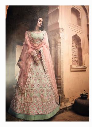 Beautiful Shade Is Here To Add Into Your Wardrobe With This Heavy Designer Lehenga Choli In Pastel Green Color Paired With Contrasting Peach Colored Dupatta. This Lehenga Choli IS Georgette Based Beautified With Contrasting Detailed And Attractive Embroidery paired With Net Fabricated Dupatta. 