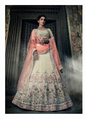 Flaunt Your Rich And Elegant Taste Wearing This Heavy Yet Subtle Looking Designer Lehenga Choli In Off-White Color Paired With Peach Colored Dupatta. This Lehenga And Choli Are fabricated on Georgette Paired With Net Fabricated Dupatta. 