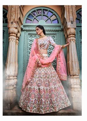 Flaunt Your Rich And Elegant Taste Wearing This Heavy Yet Subtle Looking Designer Lehenga Choli In White Color Paired With Pink Colored Dupatta. This Lehenga And Choli Are fabricated on Georgette Paired With Net Fabricated Dupatta. 