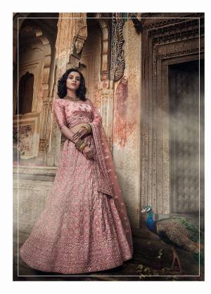 Look Pretty In This Lovely Heavy Designer Lehenga Choli In Dusty Pink Color. This Lehenga Choli IS Fabricated On Satin Paired With Net Fabricated Dupatta. It Is Beautified With Heavy Embroidery Giving You An Attractive Look. 