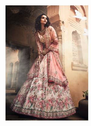 Flaunt Your Rich And Elegant Taste Wearing This Heavy Yet Subtle Looking Designer Lehenga Choli In Off-White Color Paired With Peach Colored Dupatta. This Lehenga And Choli Are fabricated on Orgenza Paired With Net Fabricated Dupatta. 