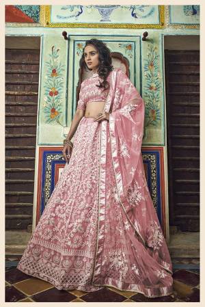 Here Is A Very Pretty Heavy Designer Lehenga Choli In Baby Pink Color. This Lehenga Choli Is Fabricated On Net Paired With Net Fabricated Dupatta. It Is Beautified With Heavy Embroidery With Pretty Pearl Highlights. 