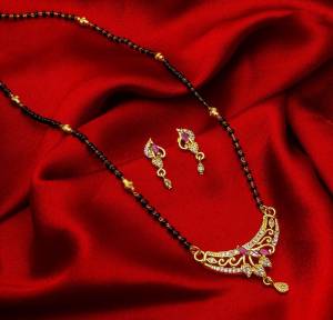 Grab This Designer Heavy Mangalsutra In Golden And Black Color Beautified With Diamond Work. This Mangalsutra Comes With A Set Of Pretty Matching Earrings. It Is Light In Weight And Easy To Carry Throughout The Gala. Buy Now.