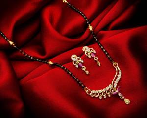 Grab This Designer Heavy Mangalsutra In Golden And Black Color Beautified With Diamond Work. This Mangalsutra Comes With A Set Of Pretty Matching Earrings. It Is Light In Weight And Easy To Carry Throughout The Gala. Buy Now.