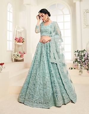 Flaunt Your Rich And Elegant Taste Wearing This Very Pretty Heavy Designer Lehenga Choli In All Over Aqua Blue Color. This Pretty Lehenga Choli Is Fabricated On Net Paired With Net Fabricated Dupatta. It Is Beautified With Heavy Tone To Tone Embroidery Giving It A Pretty Subtle Yet Heavy Look.