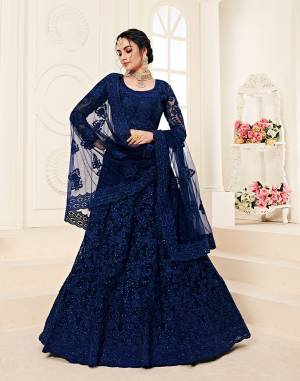 Catch All The Limelight At The Next Wedding You Attend Wearing This Very Attractive And Heavy Designer Lehenga Choli In All Over Royal Blue Color. This Lehenga Choli Is Net Based Paired With Net Fabricated Dupatta. It Is Beautified With Tone to Tone Embroidery Higihted With Stone Work. 