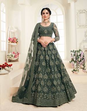 Flaunt Your Rich And Elegant Taste Wearing This Very Pretty Heavy Designer Lehenga Choli In All Over Teal Green Color. This Pretty Lehenga Choli Is Fabricated On Net Paired With Net Fabricated Dupatta. It Is Beautified With Heavy Tone To Tone Embroidery Giving It A Pretty Subtle Yet Heavy Look.