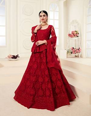 Catch All The Limelight At The Next Wedding You Attend Wearing This Very Attractive And Heavy Designer Lehenga Choli In All Over Red Color. This Lehenga Choli Is Net Based Paired With Net Fabricated Dupatta. It Is Beautified With Tone to Tone Embroidery Higihted With Stone Work. 