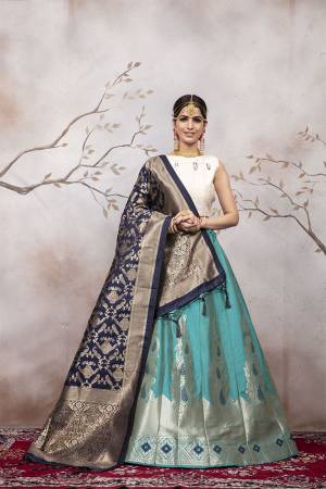 Here Is A Very Beautiful Silk Based Designer Lehenga Choli In White Colored Blouse Paired With Blue Colored Lehenga And Navy Blue Colored Dupatta. This Lehenga Choli Is Silk based Giving A Rich And Elegant Llook To Your Personality.