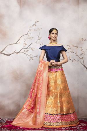 Go Colorful with Thid Very Designer Lehenga Choli In Navy Blue Colored Blouse Paired With Orange Colored Lehenga And Dark Peach Colored Dupatta. This Lehenga Choli And Dupatta Are Silk Based Beautified With Weave. Buy Now.