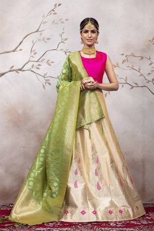 Add This Very Pretty Designer Lehenga Choli To Your Wardrobe In Rani Pink Colored Blouse Paired With Cream Colored Lehenga And Green Colored Dupatta. This Lehenga Choli Is Silk Based Beautified With Attractive Weave. Buy Now.