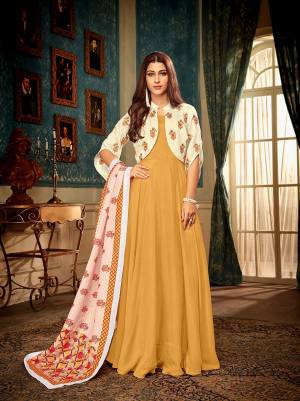 Celebrate This Festive Season With Beauty And Comfort Wearing This Readymade Deisgner Gown In Musturd Yellow Color Paired With Lovely Cream Colored Jacket And Multi Colored Dupatta. This Set Is Fabricated Muslin Which Ensures Superb Comfort All Day Long. 