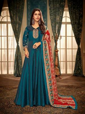 Get rEady For The Upcoming Festive And Weadding Season With This Designer Readymade Gown In Blue Color Paired With Red And Blue Colored Dupatta. This Gown Is Fabricated On Satin Georgette Paired With Muslin Fabricated Dupatta. Buy Now.