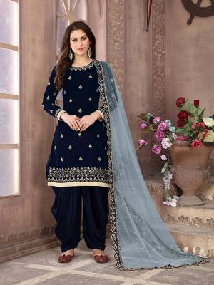 Get Ready For The Upcoming Festive And Wedding Season With This Designer Patiala Suit In Navy Blue Color Paired With Grey Colored Dupatta. Its Embroidered Top Is Fabricated On Velvet Paired With Santoon Bottom And Net Fabricated Embroidered Dupatta. It Is Light Weight And Easy To Carry Throughtout The Gala. Buy this Semi-Stitched Suit Now.