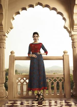 For Your Semi-Casual Wear, Grab This Designer Readymade Kurti In Navy Blue And Red Color Fabricated On Rayon Beautified With Prints. 